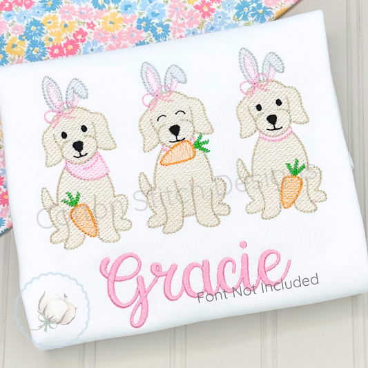 Machine Embroidery design Cotton Stitch Designs Embroidered design of three dogs with bunny ears and carrots on a white pillow with 'Gracie' embroidered.