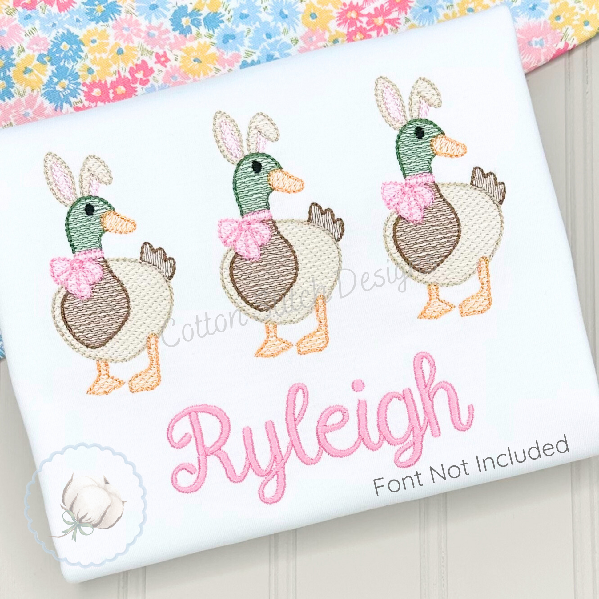 Machine Embroidery design Cotton Stitch Designs Embroidered design of three ducks with bows on a fabric with 'Ryleigh' embroidered.