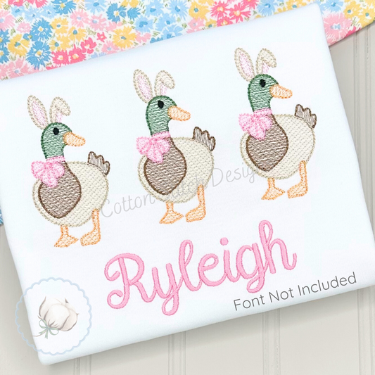 Machine Embroidery design Cotton Stitch Designs Embroidered design of three ducks with bows on a fabric with 'Ryleigh' embroidered.