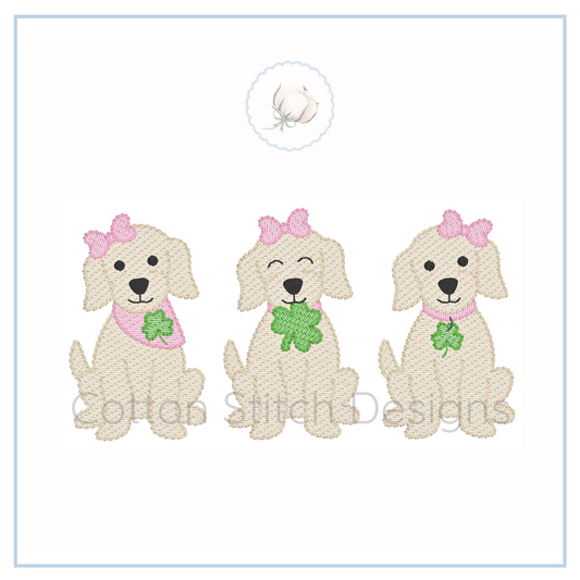 Machine Embroidery design Cotton Stitch Designs Three embroidered dogs with pink bows and green shamrocks on a white background