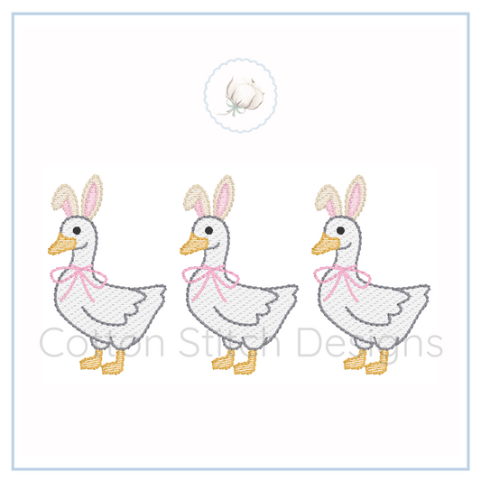 Machine Embroidery design Cotton Stitch Designs Three embroidered ducks with bunny ears and pink bows on a white background.