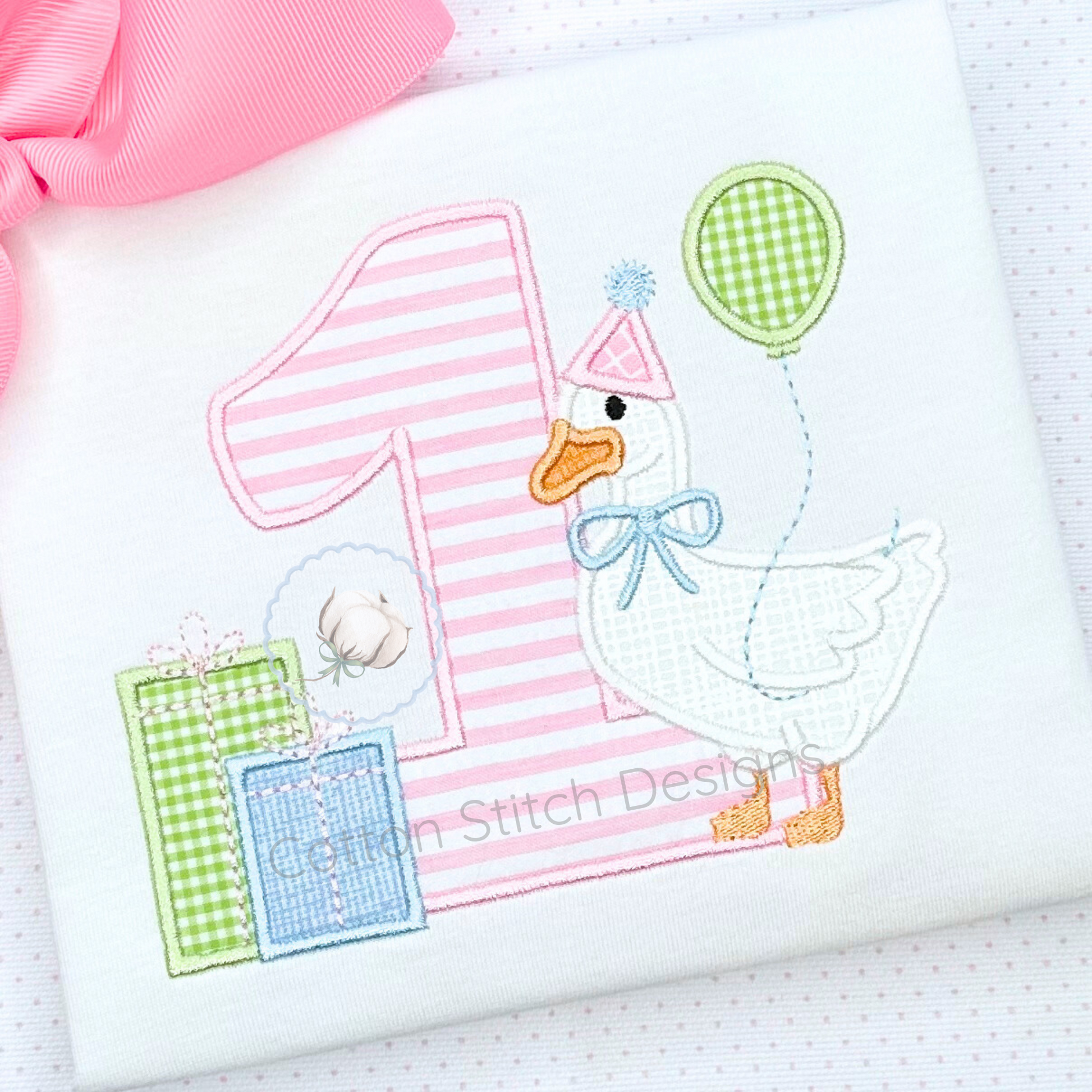 Machine Embroidery design Cotton Stitch Designs Embroidered design of a duck with a balloon and number one on a white background