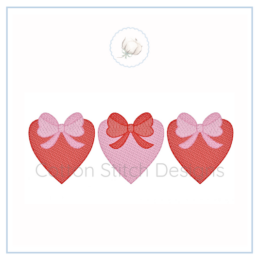Machine Embroidery design Cotton Stitch Designs Three heart-shaped stickers with bows on a white background