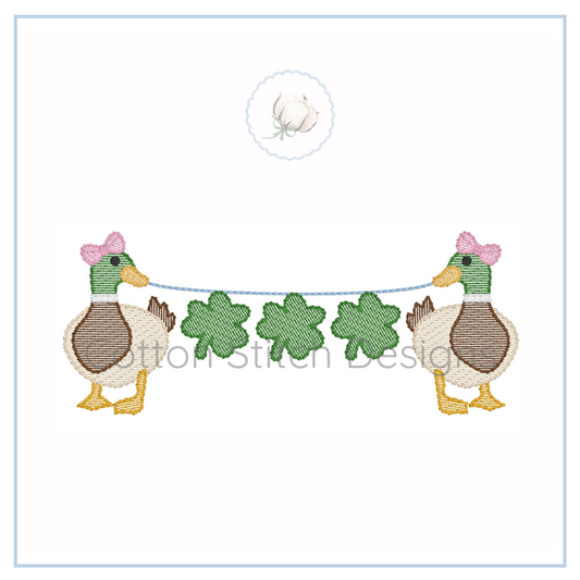 Machine Embroidery design Cotton Stitch Designs Embroidered design of two ducks with green clover leaves on a white background