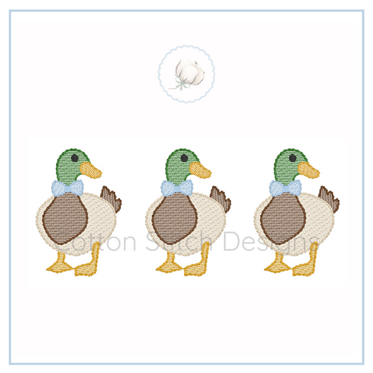 Machine Embroidery design Cotton Stitch Designs Three cartoon ducks with green heads and brown bodies on a white background
