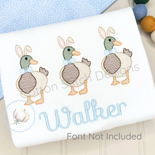 Machine Embroidery design Cotton Stitch Designs Embroidered design of ducks with bunny ears on a white fabric background.