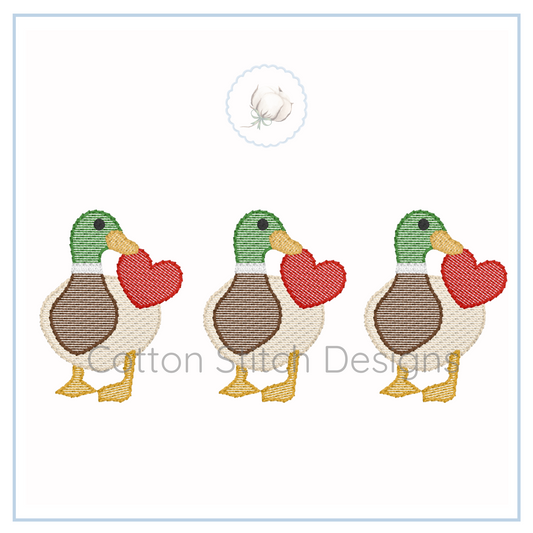 Machine Embroidery design Cotton Stitch Designs Three cartoon ducks holding red hearts on a white background with 'Botton Stitch Designs' branding.