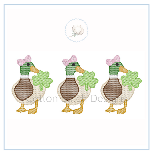 Machine Embroidery design Cotton Stitch Designs Three embroidered ducks with bows and flowers on a white background