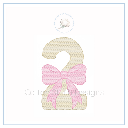 Machine Embroidery design Cotton Stitch Designs Embroidered number '2' with a pink bow on a white background, featuring the brand 'Cotton Stitch Designs'.