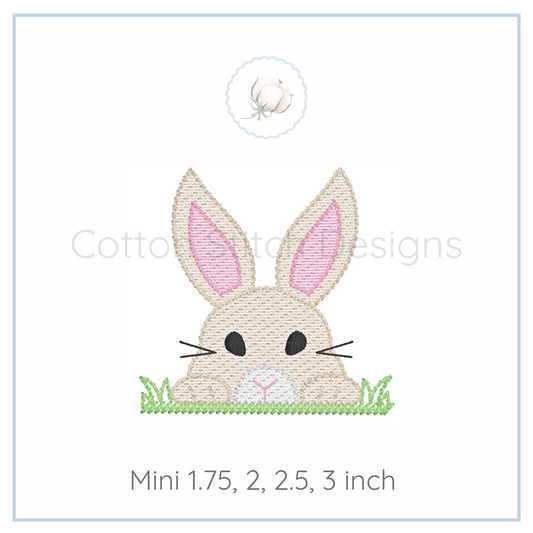 Machine Embroidery design Cotton Stitch Designs Embroidered bunny design with grass on a white background, featuring the brand 'Cotton and Clay Designs'.