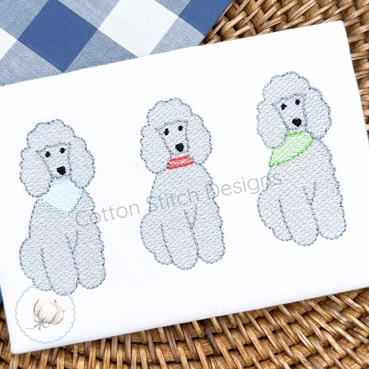 Machine Embroidery design Cotton Stitch Designs Embroidered poodles on a white fabric with a blue checkered cloth in the background.