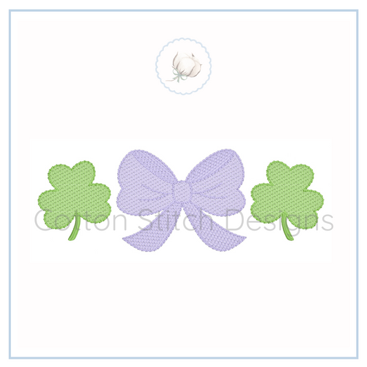 Machine Embroidery design Cotton Stitch Designs Embroidered design of a bow and two shamrocks on a white background with 'Cotton Stitch Designs' branding.