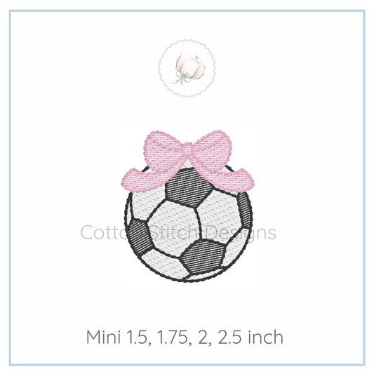 Machine Embroidery design Cotton Stitch Designs Embroidery design of a soccer ball with a pink bow on a white background, featuring the brand 'Cotton Stitch Designs'.