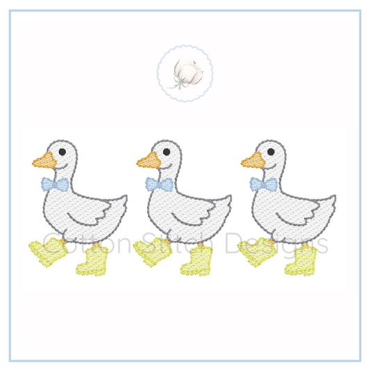 Machine Embroidery design Cotton Stitch Designs Three cartoon ducks with bow ties and rain boots on a white background