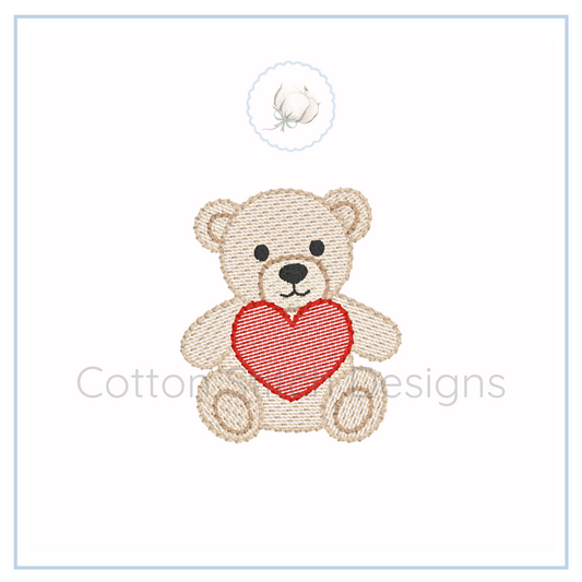 Machine Embroidery design Cotton Stitch Designs Embroidered teddy bear with a red heart on a white background, branded 'Cotton and Designs'.