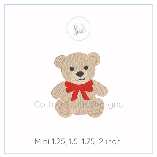 Machine Embroidery design Cotton Stitch Designs Beige teddy bear with a red bow on a white background.